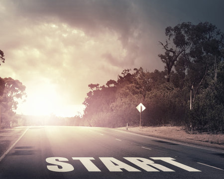 Start word as motivation writen on asphalt road