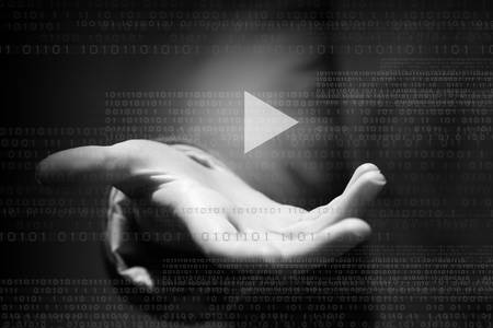 Businesswoman with media player button in palmの写真素材