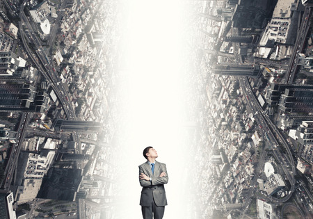 Young confident businessman with hands crossed on chestの写真素材