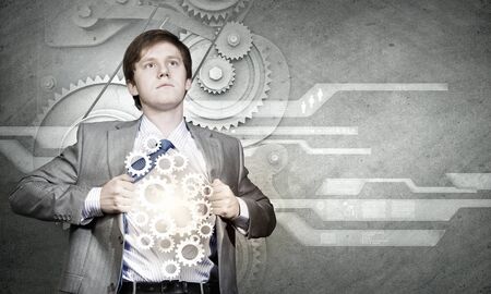Young businessman acting like super hero of creativityの写真素材