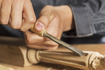 Close up of carpenter's hands working with cutter in his studioの写真素材