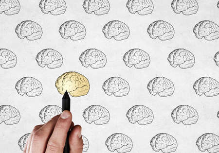 Close up of male hand drawing human brainの写真素材