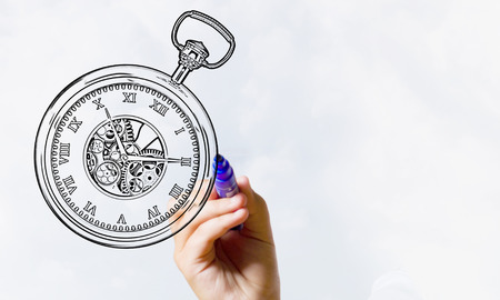 Close up of hand drawing pocket watch with markerの写真素材