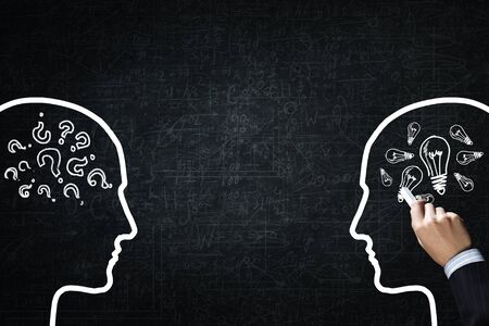 Close up of hand drawing dialogue between two on blackboardの写真素材