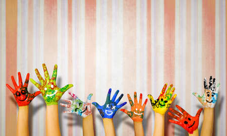 Image of human hands in colorful paint with smilesの写真素材