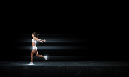 Running woman in sport wear on black background