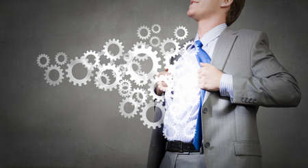 Young businessman acting like super hero of creativityの写真素材