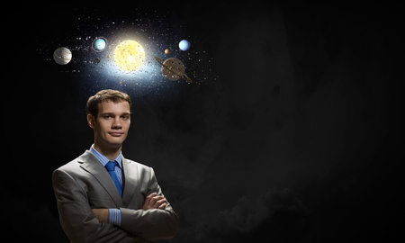 Young businessman and planets of sun system