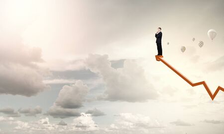 Full length of thoughtful businessman looking awayの写真素材