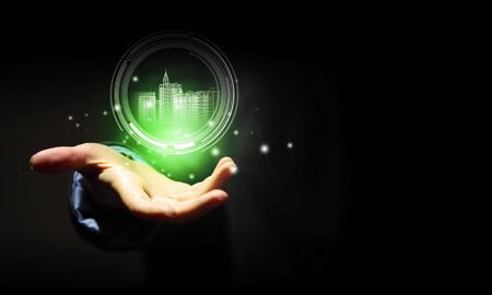 Close up of businessman hand holding digital construction modelの写真素材
