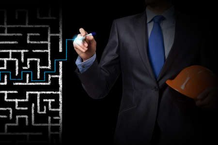 Close up of businessman drawing way out of labyrinthの写真素材