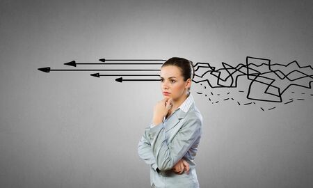 Young thoughtful woman and ideas coming out of her headの写真素材