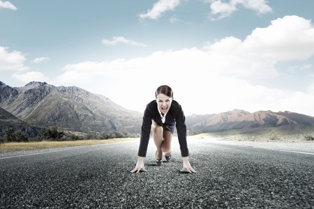 Young determined businesswoman standing in start positionの写真素材