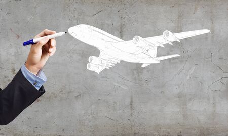Close up of hand drawing airplane with markerの写真素材