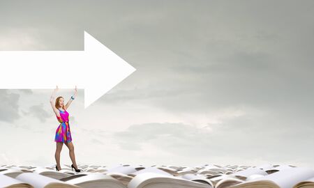 Woman in multicolored dress with arrow banner in handsの写真素材