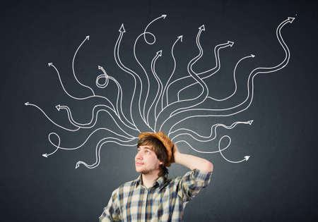 Young pensive man and thoughts coming out of his headの写真素材