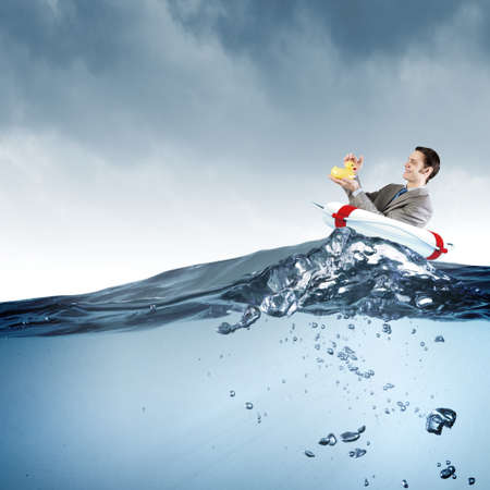 Funny businessman with yellow rubber duck toyの写真素材