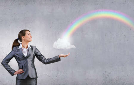 Young businesswoman holding white cloud in handsの写真素材
