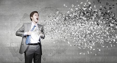 Young businessman acting like super hero of creativityの写真素材