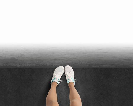 Woman standing on the edge of the roofの写真素材