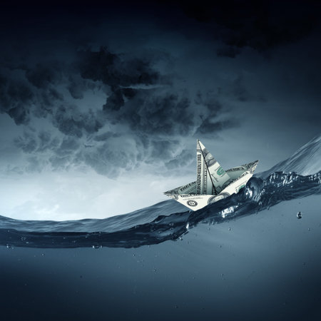 Paper ship floating on water on stormy wavesの写真素材