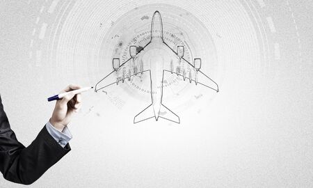 Close up of hand drawing airplane with markerの写真素材