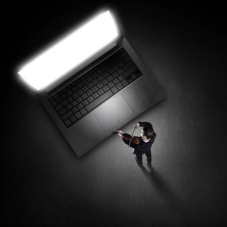 Top view of young businessman playing violinの写真素材