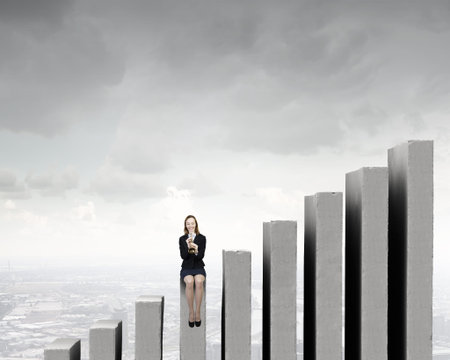 Young businesswoman in suit proclaiming something in hornの写真素材