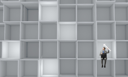 Young smiling businessman sitting with briefcase in handsの写真素材