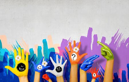 Image of human hands in colorful paint with smilesの写真素材