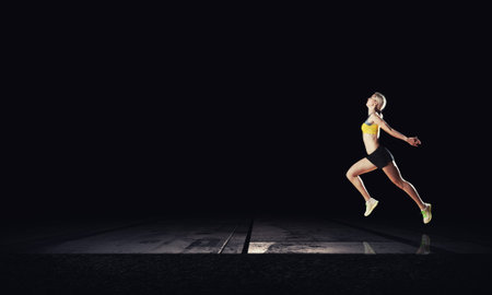 Running woman in sport wear on black background
