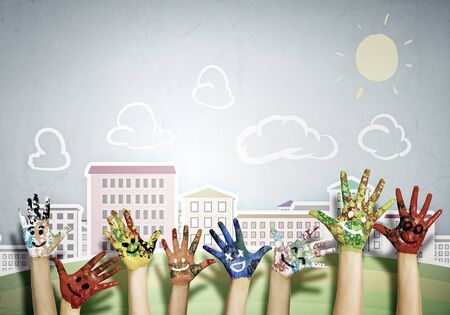 Image of human hands in colorful paint with smilesの写真素材