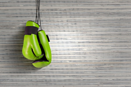 Boxing gloves hanging on nail on wall