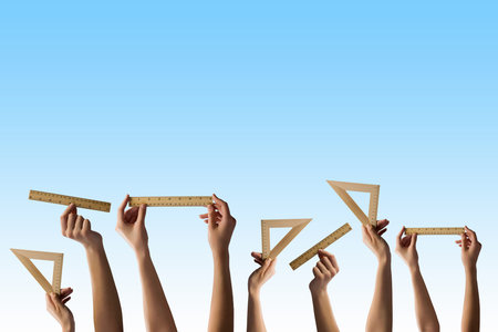 Close up of human hands holding wooden rulesの写真素材