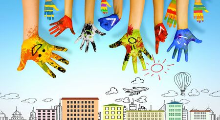 Image of human hands in colorful paint with smilesの写真素材