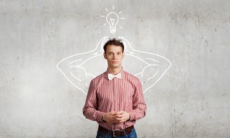 Young man with drawn strong hands behind backの写真素材