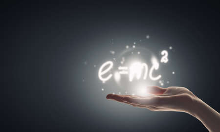 Close up of hand holding science formula iconの写真素材