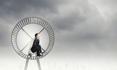 Young handsome businessman riding three wheeled bicycleの写真素材