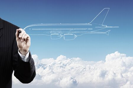 Close up of hand drawing airplane with markerの写真素材