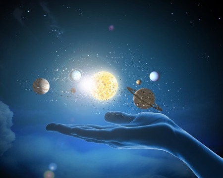 Close up of planet sun system in your handの写真素材