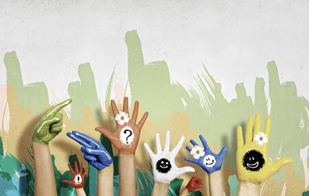Image of human hands in colorful paint with smilesの写真素材