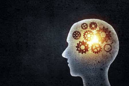 Silhouette of human head with gears instead of brainの写真素材