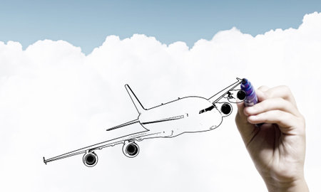 Close up of hand drawing airplane with markerの写真素材