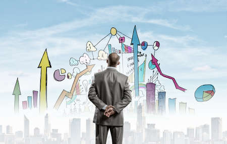 Rear view of businessman looking at business marketing strategyの写真素材