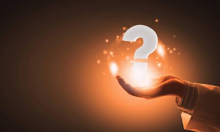 Close up of male hand holding question mark iconの写真素材