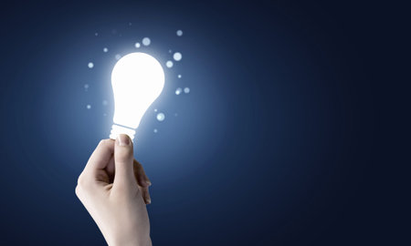 Close up of human hand holding light bulbの写真素材