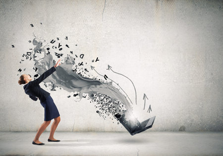 Balancing young woman evading from explosion of ideasの写真素材