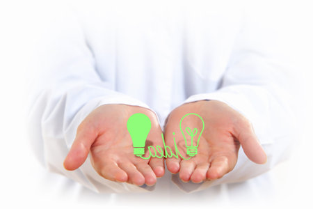 Close up of human hands with light bulb figure