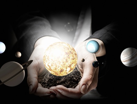 Close up of planet sun system in your handの写真素材