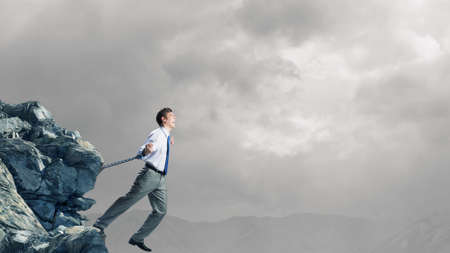 Businessman struggling with problems that occur on the wayの写真素材